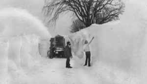 Times reporters Michael J. Greene left and Larry Cole look at a towering snowbank on County Route 61 near Tylerville -