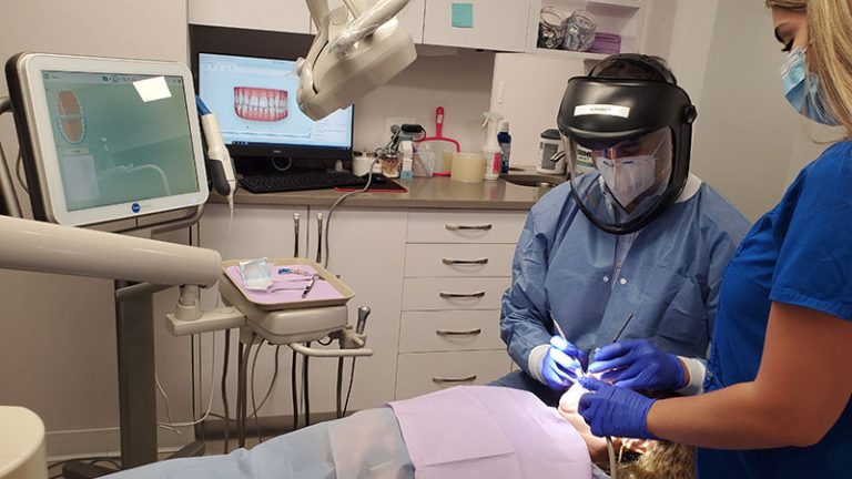 Todd Ross DDS with patient at dentist in the bronx dental clinic 768x432
